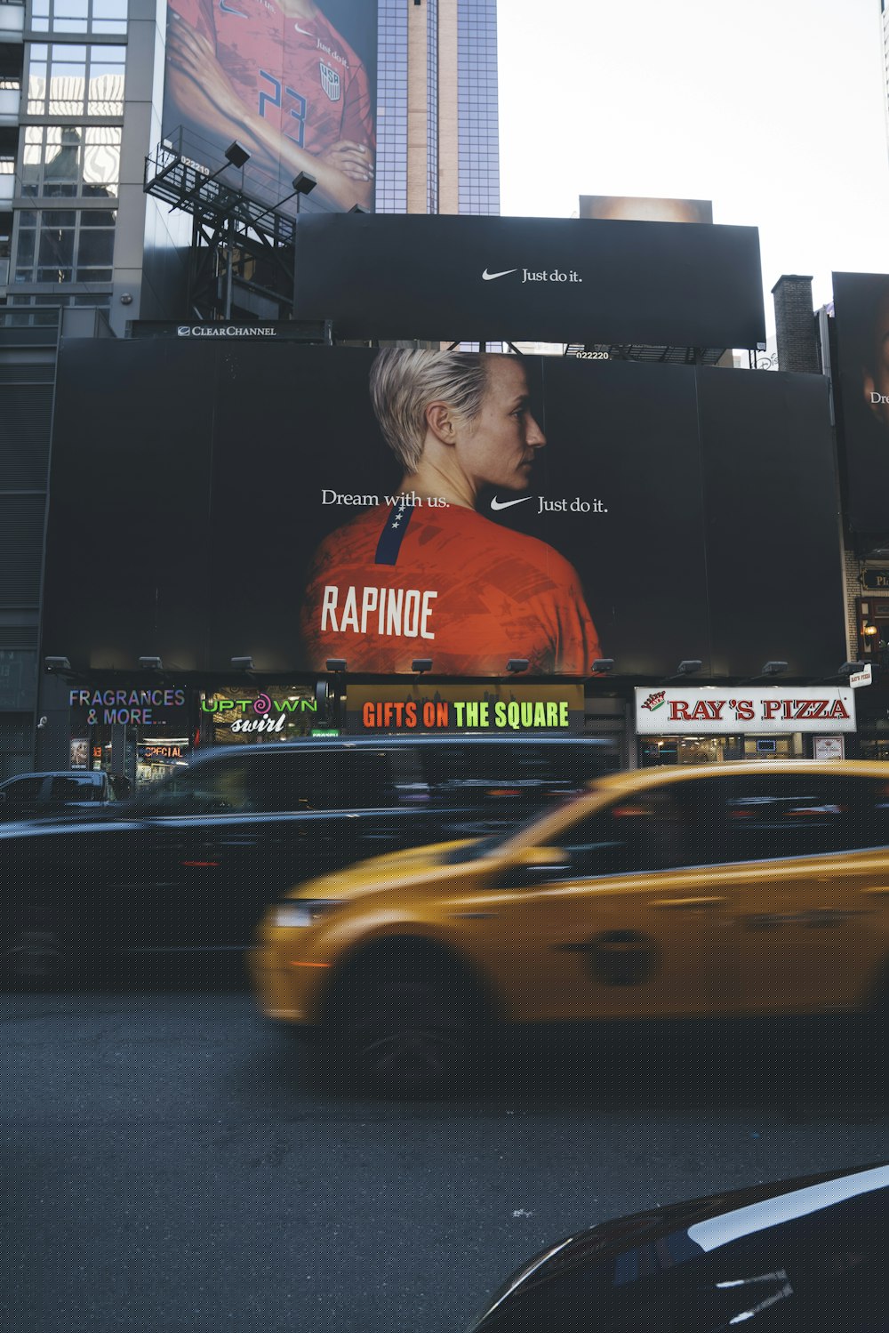 Roadside billboard advertising beside moving city traffic